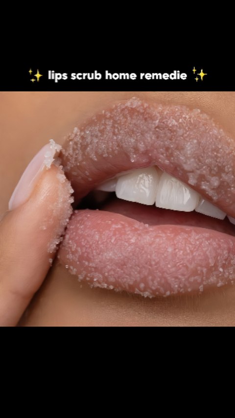 The image shows a close-up of a person's mouth, with their lips covered in a sugar scrub. The person's index finger touches their lips, and their teeth are visible. The background is solid black.
