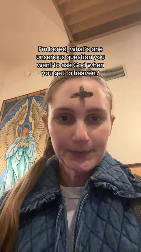 A selfie of a woman with ash cross on her forehead. She is smiling gently, in front of a painting of an angel. Text overlayed with a question about what the viewer would ask god in heaven.