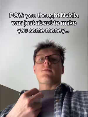 A selfie-style video with a man wearing glasses and a flannel shirt. The man is looking at the camera from a low angle, with text overlaid at the top.