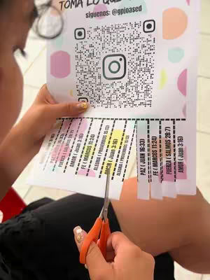 The cover image shows a woman's hands holding a paper with printed text and cutting it with orange scissors. The background includes various colors like pink, orange and white.