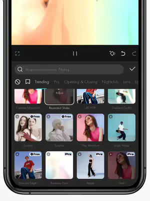 The cover image shows the screen of a smartphone where CapCut features are being showcased. The interface is dark, with a search bar at the top and various editing options displayed as icons in a grid. The background is blurred, and the phone is held against a light background. The overall composition is centered and designed to highlight the CapCut app.