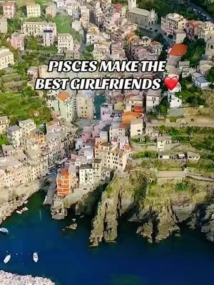 An aerial view of a coastal town with colorful buildings clustered together and a deep blue sea in the foreground. The sky is clear and the buildings are bathed in sunlight, creating a vibrant and picturesque scene. Text overlayed on the image.