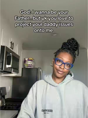 A person in a light grey hoodie and blue-rimmed glasses smiles while standing in front of a kitchen, with text overlaid on the screen.