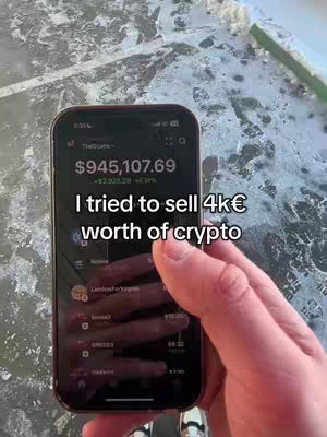 A hand holding a phone displaying a cryptocurrency app. The phone screen shows a large amount of money and the creator wrote text on the cover image.
