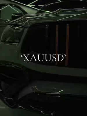 The cover image showcases a close-up view of a dark-colored vehicle's side, possibly a car. The foreground is dominated by the car's surface, with the window detail of a dark interior. The text overlayed reads "’XAUUSD’". The background appears to be lit with neon-like light sources.
