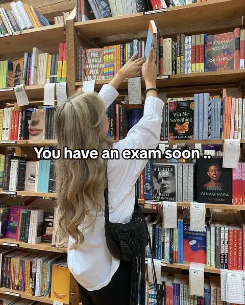A woman in a white shirt is in a bookstore, reaching for a book. Bookshelves are filled with books, creating a warm, inviting atmosphere. The text overlay reads, "You have an exam soon." 