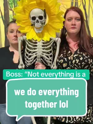 The cover image shows three people: two women and a skeleton. The skeleton wears a sunflower headpiece. The two women are positioned on either side of the skeleton. Text is overlaid, appearing in a speech bubble.