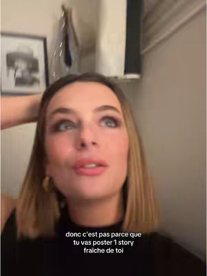 A woman is looking up, hand in her hair, black top, and text overlayed at the bottom.