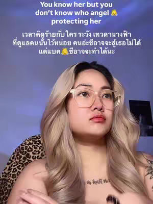 A woman with blonde hair and glasses gazes thoughtfully at the camera. Text overlays at the top of the image read 'You know her but you don't know who angel protecting her'. Additional text in Thai is also displayed on screen.