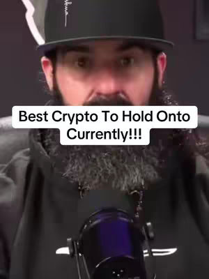 A man with a beard wearing a black cap and a hoodie is positioned in front of a microphone, with a white text box overlay that contains text about cryptocurrency.