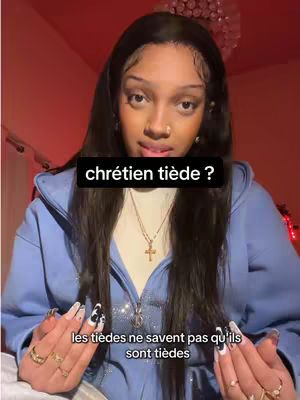 The cover image features a young woman in a close-up shot, framed from the chest up. She is looking towards the viewer and has long, dark hair, and a blue hoodie. The background is softly lit with a pinkish-red hue. Overlay text is displayed on the screen.