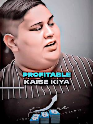 A person with a round face and light skin is the central focus, with text overlayed on the image. The person has short, cropped hair and is looking slightly off to the side with their mouth open, as if speaking. The background is blurred, but appears to be a light, neutral color. The person is wearing a dark-colored striped shirt which is slightly out of focus.. Below the person, there are a set of graphics depicting money bills and an upwards pointing arrow. The superimposed text is in a colorful, bold font, including the phrase 'PROFITABLE KAISE KIYA'. The image creates a sense of financial advice or explanation.
