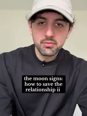 A man with short dark hair and a goatee is centered in the frame wearing a black t-shirt and a light gray baseball cap. A black rectangle overlay at the bottom displays white text.