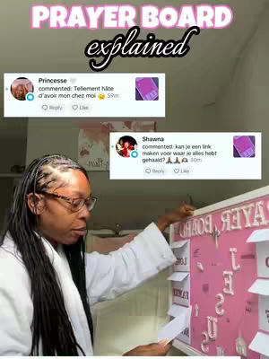 The image shows a woman in a white robe holding a piece of paper and interacting with a pink prayer board. The board has white letters spelling the words "JESUS, LOVE, US" and other handwritten notes. Above her, there are two social media-style comment sections with user profiles and text.