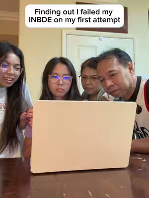 A cover image shows four people gathered around a laptop, their faces focused on the screen. Above the scene is a white rectangular text overlay. The group includes two young women, an older woman, and an older man, all appearing to be looking at something on the laptop with expressions of concern. The setting is a domestic interior, and the general lighting suggests a well-lit room.