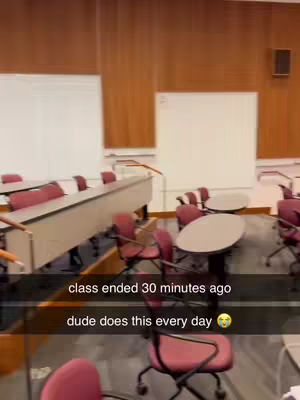 The cover image depicts an empty classroom setting. The perspective is from a somewhat low angle, looking through the room. Rows of desks with burgundy-colored chairs are visible, with empty whiteboards in the background. The lighting suggests the room is well-lit. Text overlays that read 'class ended 30 minutes ago' and 'dude does this every day' with a crying emoji in a black rectangle.