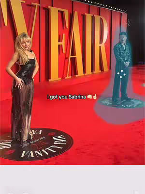 The cover image is a red carpet scene at an event, with a large gold "VANITY FAIR" backdrop. A woman in a black dress stands on a circular platform with a "VANITY FAIR" logo, and on the right, a man is shown with a teal-halo effect, as if a ghost is positioned inside. The text overlay reads, "i got you Sabrina".