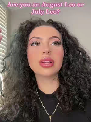 A woman with curly dark hair and noticeable makeup is centered in the frame, gazing upwards with a thoughtful expression. A necklace dangles around her neck. The background is blurred, suggesting an indoor setting with a window. Text overlay highlights the topic.