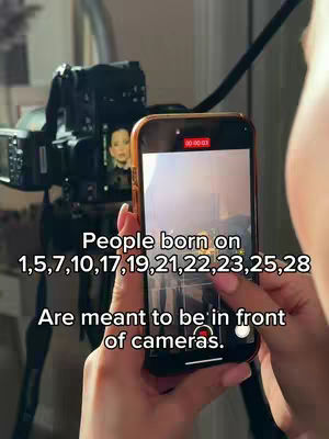 A cover image shows a person holding up a phone to film. The phone screen shows a preview of a picture against a blurred background. A professional camera on a tripod is behind the phone along with lights, suggesting a studio setting, while text overlays the image with information.