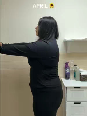 The cover image shows a woman standing in profile in a room with white walls and a white cabinet. She is wearing a black outfit and has her arms outstretched. The text 'APRIL' is at the top.