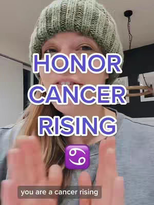 A woman is centered in the cover image and wearing a grey hoodie and a green knit beanie, and the background is blurry. Overlaid on her is a text element reading 'HONOR CANCER RISING', with 'CANCER RISING' in a larger font size and within an oval with a purple to white gradient filling. A purple cancer zodiac symbol sticker is below, and a banner at the bottom reads 'you are a cancer rising'. The woman's hands are spread apart in front of her with her index fingers pointing up and away from her.