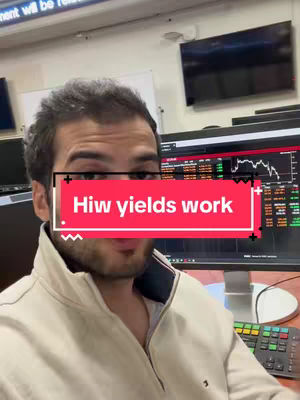 A man in a tan jacket is centered in the frame, with the text "Hiw yields work" overlaid on a red rectangle covering most of his face. The background includes computer monitors displaying financial data and a room setting with muted colors.