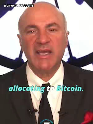 The image features a man in a suit speaking to the camera. Text overlayed on the image reads 'allocating to Bitcoin'. The background is slightly blurred and includes a partial view of a design or logo.