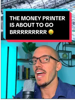 A video cover features a man, presumably the creator, speaking into a microphone. Above him, a black banner displays text against a background of folded money. The man is wearing glasses and a blue shirt, with a focused expression. The background suggests a home setting with a shelf, plants, and a lighting setup. The overall composition conveys a financial or commentary theme, with the money background setting the context.