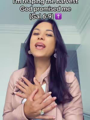 A woman with dark hair and fair skin is seen from the chest up, gazing slightly upward with an open mouth. Her hands are clasped over her chest. The background is a combination of light and dark solid colors.