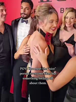 A group of people pose on a red carpet. Sydney Sweeney is a central subject, with her arm around another person's waist. A text overlay provides context, reading 'POV: You meet the "nice" person everyone likes but something feeling off about them.' The lighting is bright, and the general composition conveys a sense of a social gathering or event.