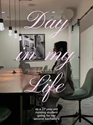 A person sits at a conference table indoors, appearing to be studying or working on a laptop. The image has text overlaid with the text 'Day in my Life'.