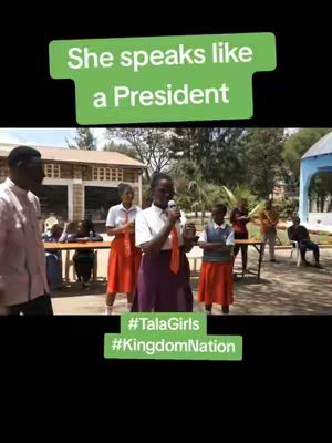 The cover image showcases a group of young girls, likely in a school setting. A girl with a microphone stands in the center, speaking, with a green text box above her head that reads She speaks like a President. Others appear to be in the background, with tables and a building in the background.