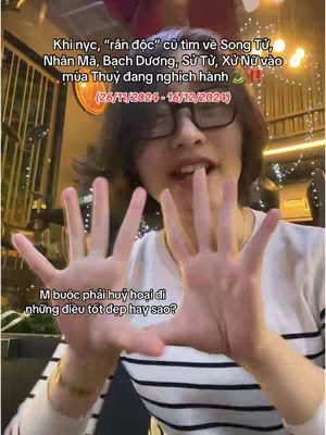 A person wearing glasses and a striped shirt is holding out both hands towards the camera, framed from the chest up. The background suggests an indoor setting with some bokeh lights and a plant. Text overlays describe astrology and a specific time period.