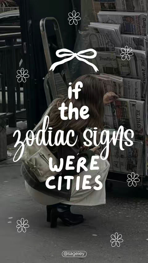 A photo with a dark, muted color palette. A person in casual attire crouches on a city sidewalk, facing a newsstand. White text overlays, the phrases 'if the zodiac signs were cities,' are styled with a handwritten-like font. Delicate white flower illustrations are scattered throughout, and the @sageiey username is visible in the bottom corner.