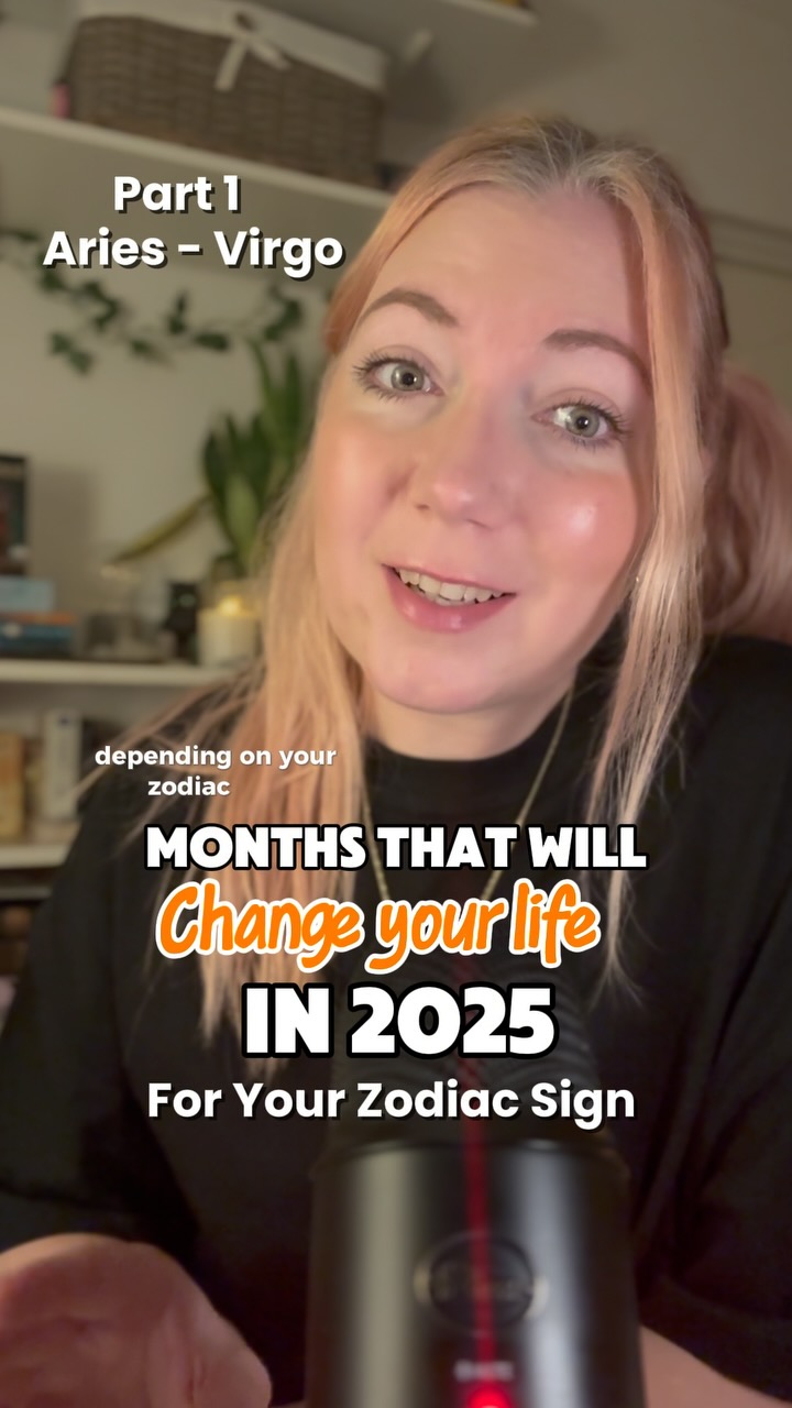 A selfie-style video cover featuring a woman with blonde and light pink hair, positioned at the upper center. The background is softly blurred, including shelves with items and a hint of a room corner on the left. The image uses a warm color palette, with focus on the woman's face and the overlaid text. The woman is looking at the camera and speaking. A black microphone is in the lower part of the image.