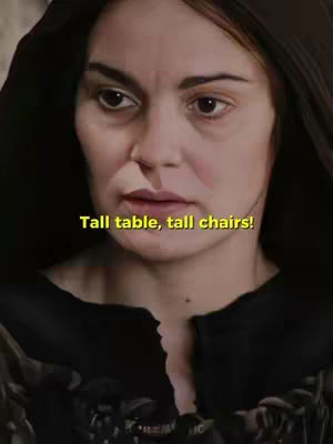 A close-up shot of a woman's face with a neutral expression. She appears to be in a dark setting. The background is blurred, focusing attention on her face. There are yellow text overlays on her face.