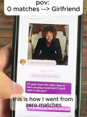 The image shows a person holding a smartphone displaying a dating app interface. The app shows a conversation with a message from a user named Paige, accompanied by a photo of a man sitting, inside a van, and wearing a black jacket. The phone is being held in a hand.