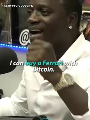A close-up shot of Akon, dressed in a white shirt, speaking. Text overlayed says, 'I can buy a Ferrari with Bitcoin.' The background is a blurry interior setting.