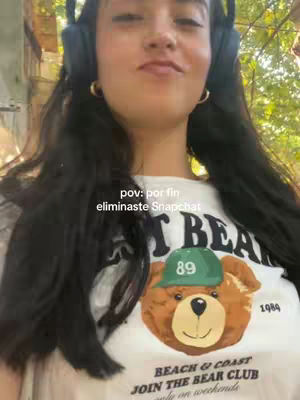 A woman wearing headphones and a t-shirt with a bear graphic smiles at the camera. Text overlays the image.