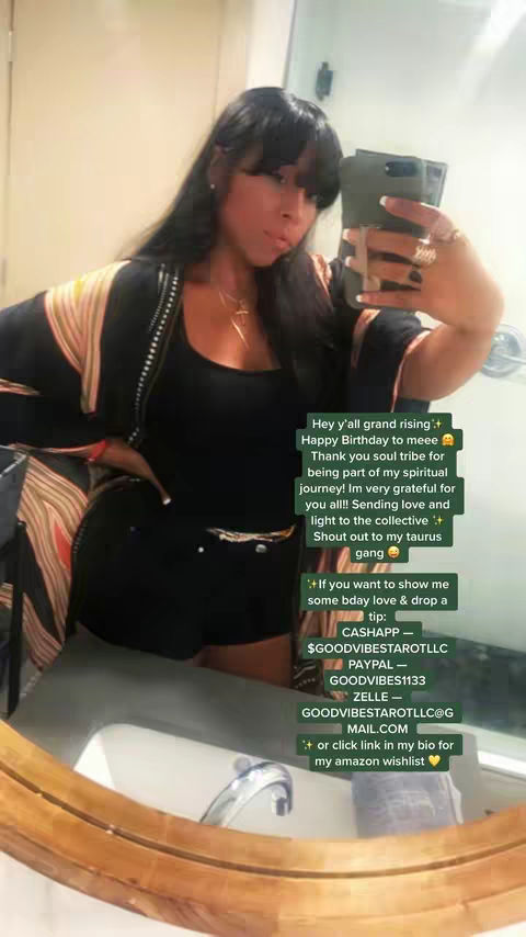 A selfie-style image features a woman of color with long, dark hair and a stylish outfit. She is holding a phone, likely taking the picture, and has a message overlayed to the side.