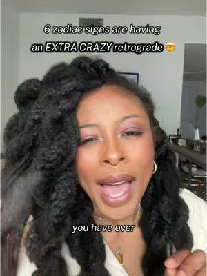 A woman with dark, voluminous curly hair is centered, looking directly at the camera with her mouth open, as if speaking. The background is slightly blurred, but a white wall and bits of furniture are visible. Text overlays state the video's subject.