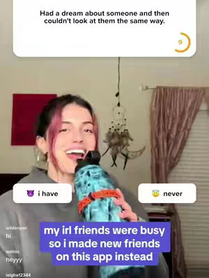 A woman with pink highlights in her dark hair holds a large blue and orange water bottle, smiling. A purple bar with white text, 'my irl friends were busy so i made new friends on this app instead', is at the bottom. To the upper left, a purple devil emoji with the text 'i have' in a white block. To the right, a yellow smiley emotion with the text 'never' in a white box.  In the background, a red piece of art on a wall and striped curtain.