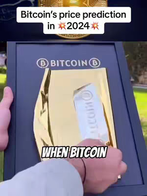 The cover image shows a person holding a presentation board with the Bitcoin logo. The board is enclosed in a black frame and set against a background. The person's hands are prominently featured, holding a gold-colored item inside the frame. Text overlays are used to make the hook.
