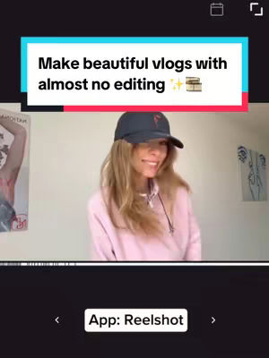 A woman in a pink hoodie and a black cap is smiling and gesturing with her hands. The background is a white wall. The image has text overlay at the top that says: "Make beautiful vlogs with almost no editing". The overlay has a teal background and red text on top. The app logo is shown is is at the bottom.