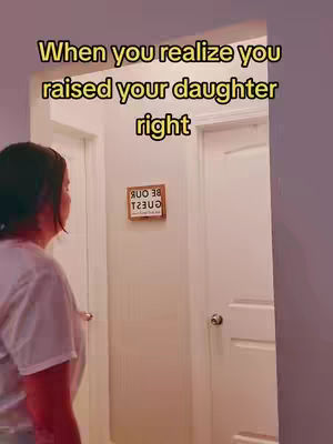 The cover image shows a woman standing in a hallway, with a text overlay. The woman is wearing a light-colored top and is looking towards the doors ahead. The hallway has white walls and doors. There is a sign on the wall, and the text 'When you realize you raised your daughter right' is overlayed in the image in a yellow font.