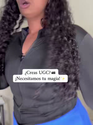 A woman with curly dark hair is captured from the chest up. She's wearing a black zip-up athletic jacket over a darker top and has blue athletic pants. A text overlay in a white rectangular box features white text, which asks the camera operator a question.