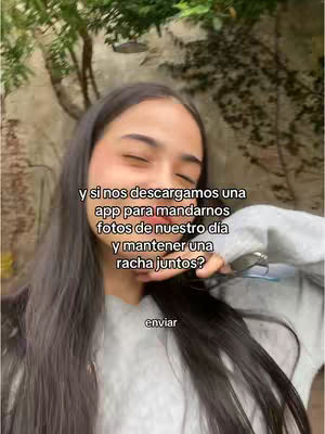 A selfie shot shows a young woman with long dark hair against an out-of-focus green background. She's wearing a gray sweatshirt and has text overlays on the image.