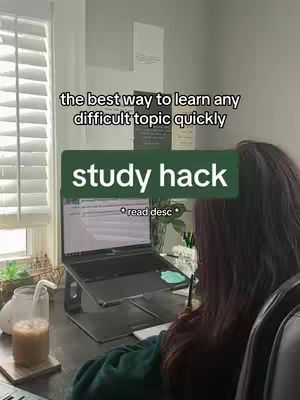 A person with long red hair is sitting at a desk with a laptop on a stand. In the background there is a window with blinds, the top of the window is out of frame. There is a green stripe graphic with white text over the image.