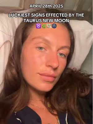 A woman with fair skin and brown hair reclines on a bed, looking directly at the camera. Text overlays at the top read, 'APRIL 28th 2025 LUCKIEST SIGNS EFFECTED BY THE TAURUS NEW MOON,' alongside astrological symbols. The image is well-lit, with a focus on the woman's face.