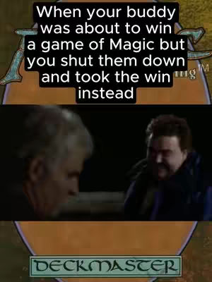 The image is a meme template based on a film scene. The central element is the interaction between two middle-aged men, one looking disheartened while the other has a mischievous smirk. Overlay text at the top states a scenario relevant to Magic: The Gathering, and a 'Deckmaster' logo is visible at the bottom. The color palette is muted, with a focus on realistic skin tones and ambient lighting, typical of the source material.